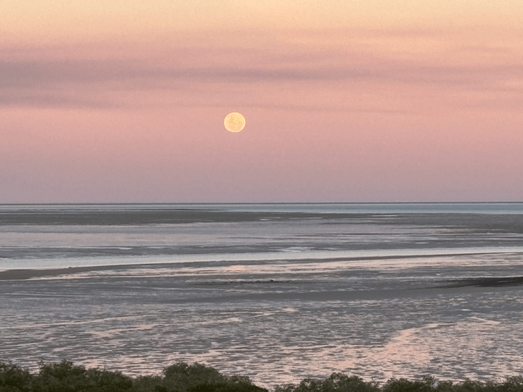 Full moon over the peaceful Kimberley coastline at dusk, capturing the calm, restorative beauty of nature that supports intentional rest and reflection.